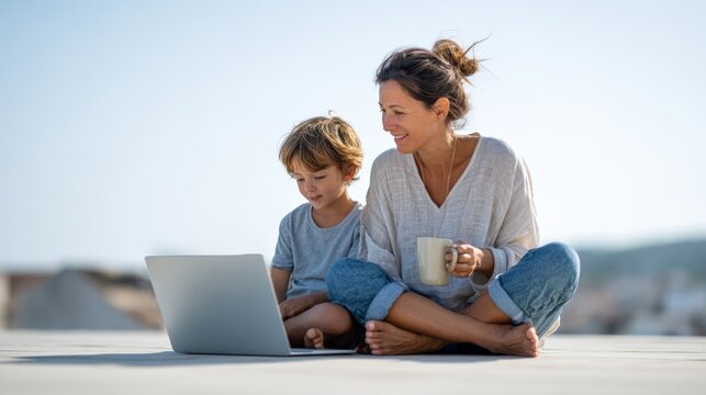Mother enjoys a cup of coffee while her son uses a laptop, embodying the work and travel lifestyle, suggesting a blend of remote work and family time