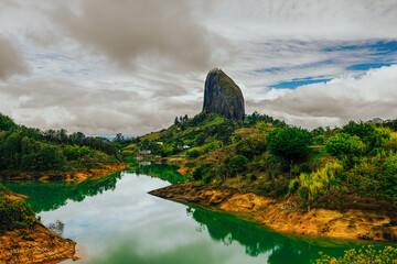 Overcast view of the Peñol Rock in Guatapé, Colombia, with the reservoir forming a winding path...