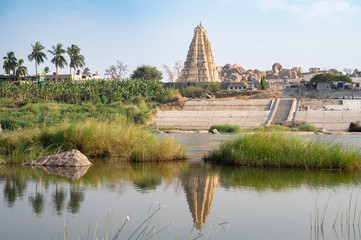 Hampi, view from Hippy island, Virupaksha temple and tungabhadra river, India, historic monument of the ancient Vijayanagara Empire civilization, hinduism culture and religion
