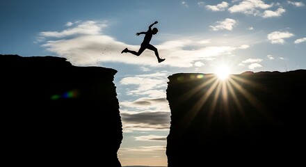 Man Jumping Over Cliff Silhouette Against Bright Sunset Sky