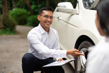 Insurance Consultation. Professional agent assisting a client with vehicle inspection outdoors.