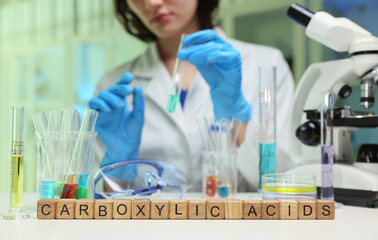 A dedicated scientist is conducting a comprehensive study on carboxylic acids using advanced...