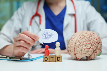 In a clinical setting, a knowledgeable doctor discusses brain health thoroughly using models and...