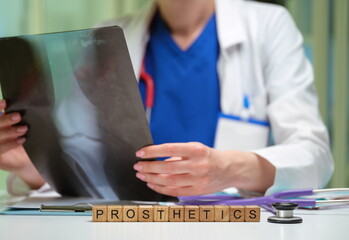 A skilled medical professional is analyzing a detailed Xray image related to prosthetics in a...