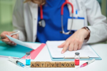 A healthcare professional is preparing antivenom for snake bite treatment in a clinical environment.