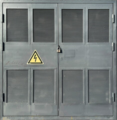 Industrial metal door with high voltage warning