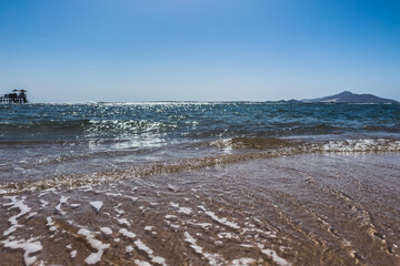 Sea to the horizon, pier and view of Tiran Island. Selective focus. Vacation at sea.