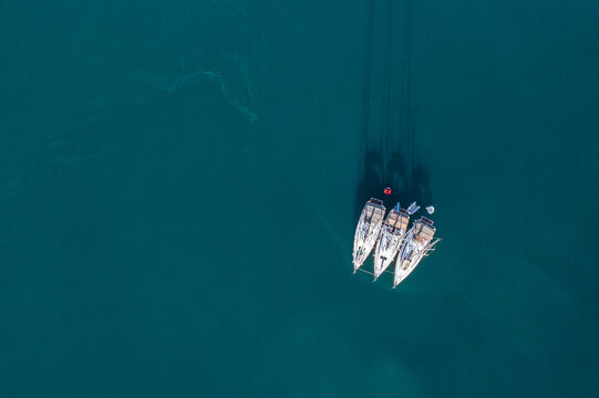 Aerial view of boats floating on the deep blue sea water, Fjord Lim, Istria County, Croatia.