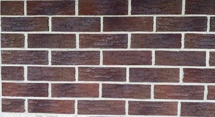 Textured red brick wall with white mortar joints as a classic architectural background for design or construction content