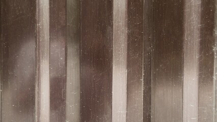 Industrial brown metal texture with vertical stripes and scratches — ideal background for technical and industrial themes