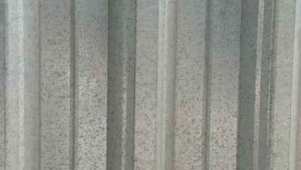 Fototapeta premium Rough texture of dark gray metal profile with vertical ridges — a technical and architectural element for industrial themes