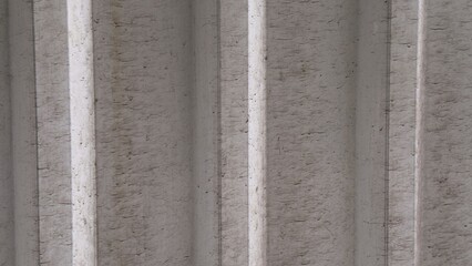 Rough texture of dark gray metal profile with vertical ridges — a technical and architectural...