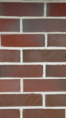 Red brick wall with white mortar and horizontal layout as background for architectural or design...