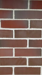 Red brick wall with white mortar and horizontal layout as background for architectural or design content