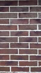 Red brick wall with white mortar and horizontal layout as background for architectural or design content