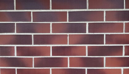 Red brick wall with white mortar lines and black spots — classic texture for architectural, construction, and design projects