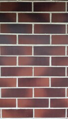 Red brick wall with white mortar lines and black spots — classic texture for architectural,...