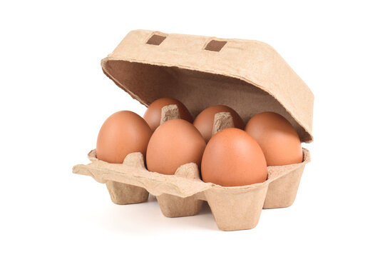 Open egg box with brown eggs isolated on white background with clipping path. Fresh organic chicken eggs in carton pack or egg container