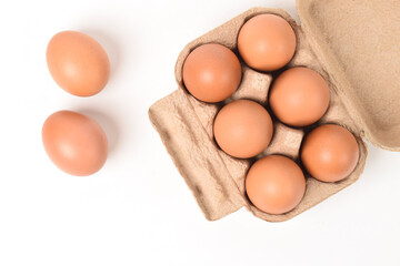 Eggs in paper tray isolated on white background. Top view