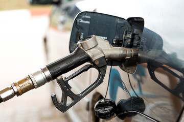 Gas station. Refueling a car with gasoline. Fuel dispenser in the car's fuel tank at a gas station....