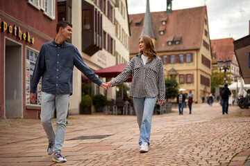 Young Cute Female Hugs Boyfriend. In Autumn Outdoor. Lovers Walking in Park. Attractive Funny Couple. Lovestory in Forest. Man and Woman. Cute Lovers in the Park. Family Concept. Happy Couple.