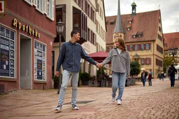 Young Cute Female Hugs Boyfriend. In Autumn Outdoor. Lovers Walking in Park. Attractive Funny Couple. Lovestory in Forest. Man and Woman. Cute Lovers in the Park. Family Concept. Happy Couple.