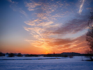 A beautiful sunset over a snow-covered field