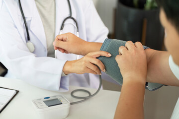 Healthcare. Nurse measuring blood pressure of patient.