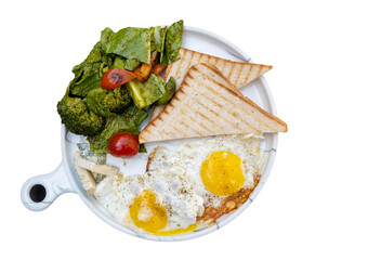 two eggs fried with stewed vegetables and toast bread on a white ceramic frying pan, top view, isolate