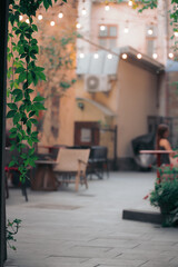 cafe outdoor patio tables background silhouettes resting people vertical picture