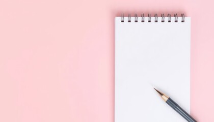 Blank notebook, pink background, pencil