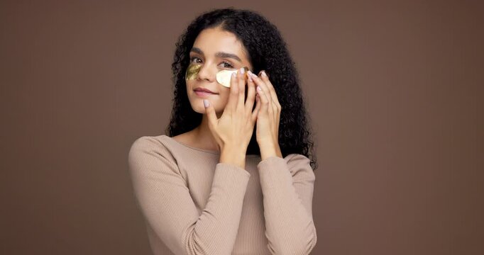 Happy woman, face and studio with eye patches for collagen or vitamin C on brown background. Portrait, female person or model with facial mask for anti aging treatment or hydro gel on mockup space