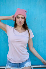 Young urban model posing with pink beanie and casual clothes