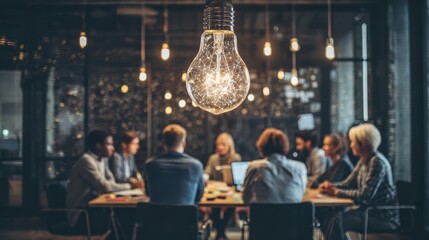 Business meeting with illuminated light bulb overhead in modern office space emphasizes collaboration and innovation among diverse professionals gathered around table
