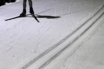 Cross-Country Skier in Action on Snowy Evening Outdoors
