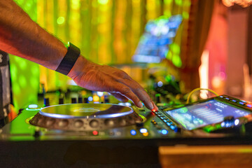 DJ Mixing at Vibrant Nightclub with Golden Lights