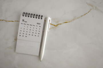 Hello, September 2025. Desktop calendar for planning on an abstract background.