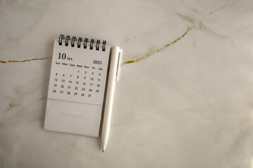 Hello, October 2025. Desktop calendar for planning on an abstract background.