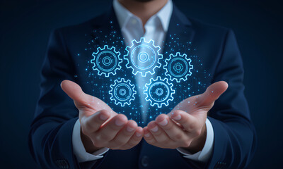 Businessman holding a glowing digital gear hologram, symbolizing business process automation, innovation, and system integration. Conceptual design for technology, s