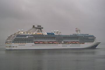 Modern Princess cruiseship cruise ship liner Coral arrival into Vancouver, Canada port on grey...