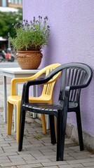 Fototapeta premium Five chairs in purple and yellow stand against a dark background, showcasing contrast and symbolizing diversity in a workspace