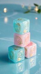 A close up of stacked translucent dice with swirling gold patterns on a blue reflective surface