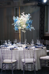 table setting with blue flowers and napkins.