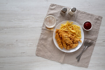 Homemade Chicken Strips with Fries on a Plate, top view. Space for text.