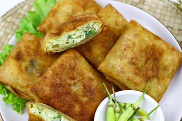 Martabak telur, Indonesian popular folded omelet made from egg, green onion, and wrapped with crispy dough. Isolated background.