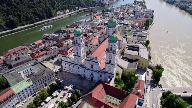 Wide aerial drone shot of St. Stephen's Cathedral, Danube and Inn River in Passau, UHD