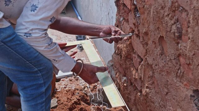 Construction Workers Aligning Column layout with String line and Set Square. day time, stable shot, 4k.