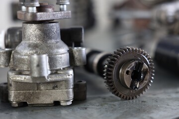Different auto parts on grey table indoors, closeup