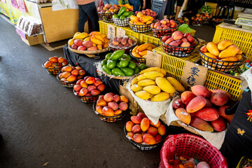 Tainan, Taiwan – Jun 30, 2025: Display of fresh mangoes at Yujing Fruit Market. The market is a major hub for Taiwan’s mango harvest, attracting locals and tourists during summer fruit season.