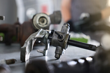Auto part. Manual transmission on grey table indoors, closeup